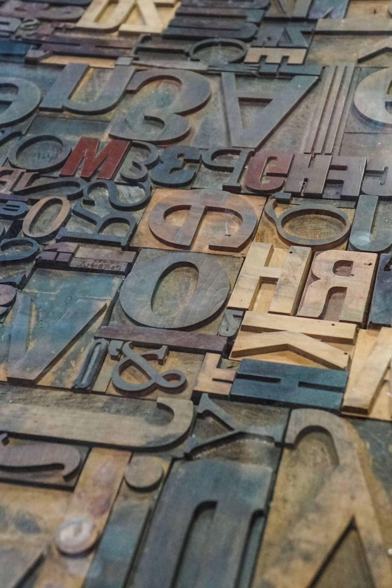 Bild mit verschieden großen Holzlettern, die zu einem Mosaik zusammengefügt sind